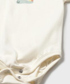 Cream colored baby onesie with a small pastel rainbow and smiling snail graphic on the chest