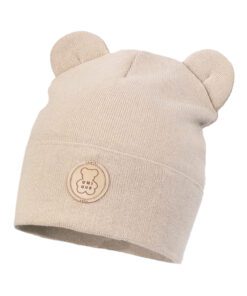 Beige knitted baby hat with two ears and a circular bear emblem on the front.