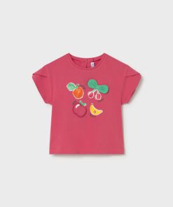 Pink kids' T-shirt with a colorful fruit graphic—orange, apple, lemon slice, and cherries with a green bow.
