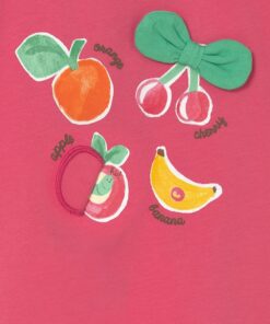 Pink fabric with four playful fruit graphics—orange, cherries, apple, and banana—plus a green bow tattooed on the shirt edge, labeled with their names.