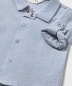 Light blue knitted baby polo shirt with a collar button placket and rolled cuff sleeve detail newborn size
