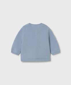 Back view of a light blue knitted sweater with long sleeves and ribbed cuffs and hem