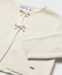 Cream knit toddler cardigan with two fabric bow closures and ribbed texture