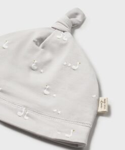 Light gray baby hat with a knotted top and small white embroidered birds tag visible on side