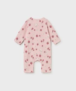 Back view of a pink baby onesie with a scattered red apple print and long sleeves