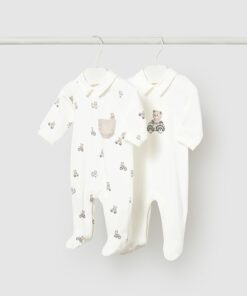 Two white baby onesies hanging on a clothes rod; one has tiny bear/ bicycle prints and a pocket, the other is plain with a bear on a tricycle.
