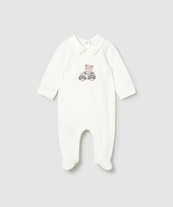 White baby onesie with a bear riding a bicycle embroidery on the chest long sleeve and footed