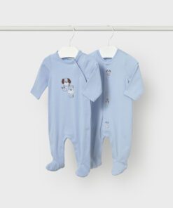 Two light blue, footed baby sleepers hanging on white hangers from a rod, one with small dog embroidery on the chest.