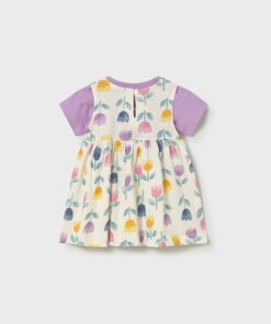 Girls short sleeve dress with lavender sleeves and a cream fabric covered in colorful tulip style flowers back button closure at the neckline
