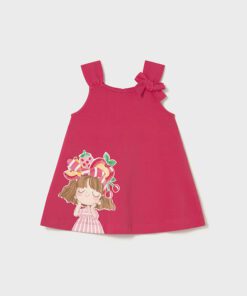 Pink sleeveless dress for a young girl with a large fabric bow on one strap and a cartoon girl graphic near the hem.