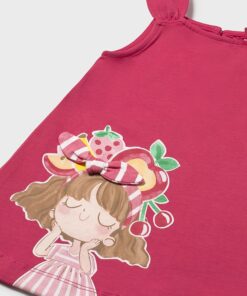 Pink children's dress with a sleeping cartoon girl print and fruit-themed headband embellishment on the lower front.