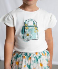 Young girl wearing a white t shirt with a light blue purse and daisy graphic paired with a teal floral skirt with orange accents