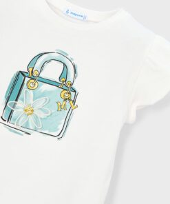 White T shirt with a turquoise handbag print featuring a daisy and gold initials ML on the front
