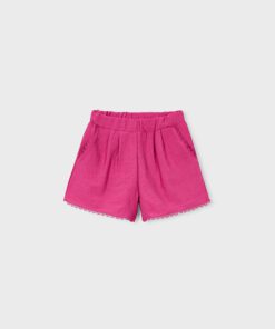 Pink shorts with an elastic waistband and scalloped lace trim at the hem designed for children