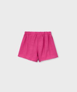 Pink shorts with an elastic waistband and scalloped lace trim along the hem