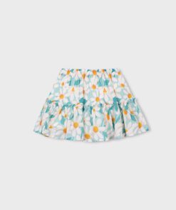 Tiered girls skirt with a teal and white daisy pattern and yellow centers