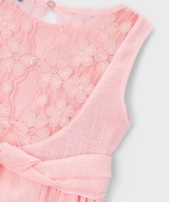 Light pink sleeveless dress with floral lace back panel and a tied waist shown as a close up product photo