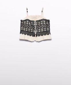 Beige strapless cropped top with an ornate black lace overlay across the front